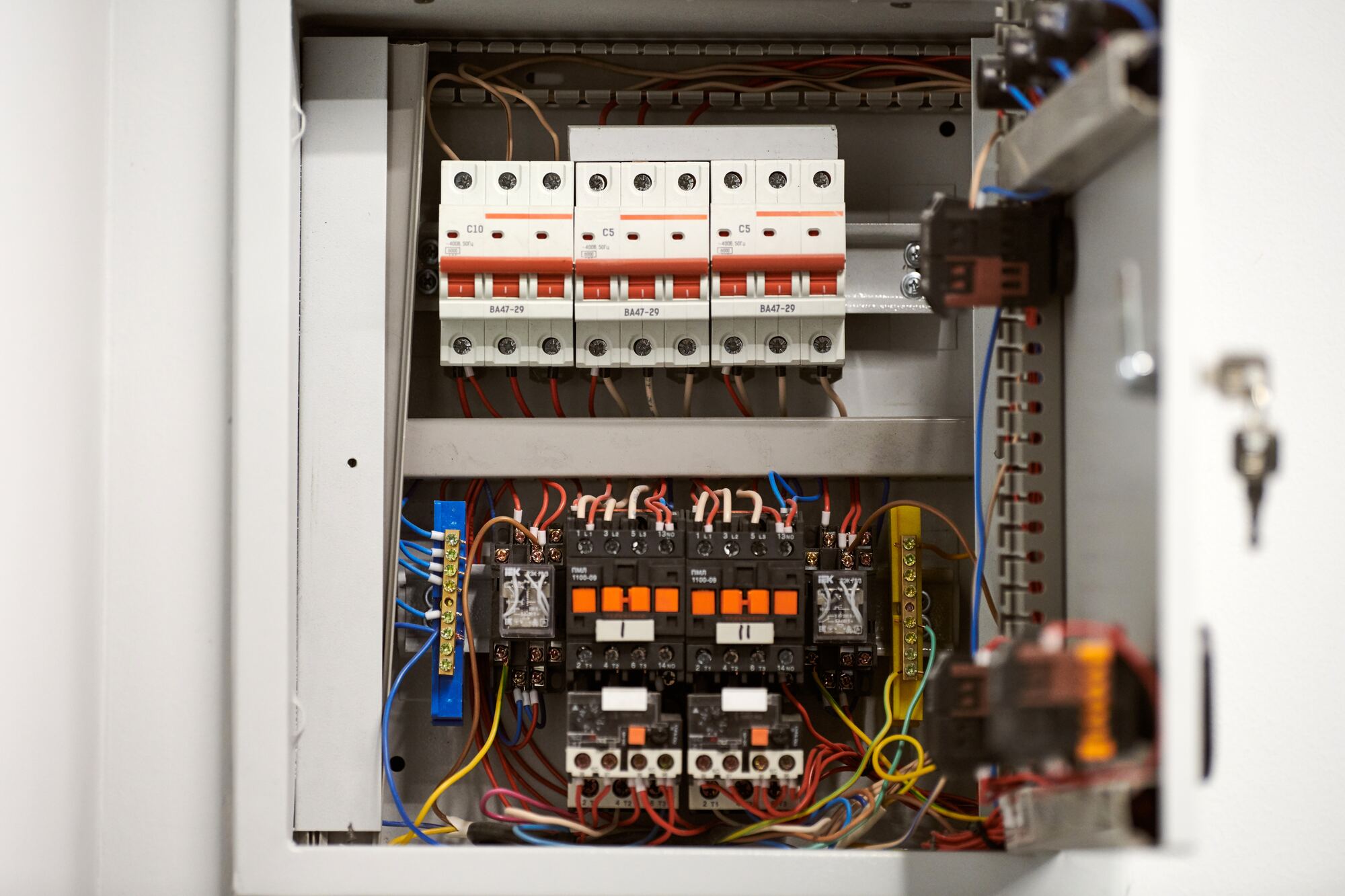 Electrician working on an open breaker panel